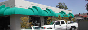 Image of fixed awning wrapping around a business front.